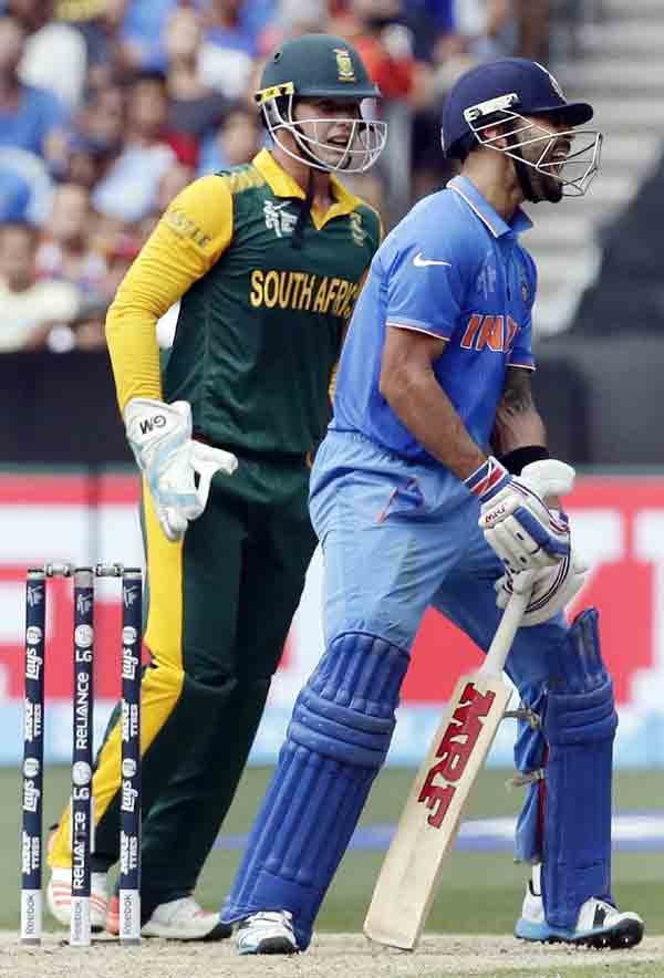 IND vs SA: आईसीसी क्रिकेट विश्व कप के पूल बी के एक मैच में मेलबोर्न क्रिकेट ग्राउंड पर दक्षिण अफ्रीका के खिलाफ 46 के निजी स्कोर पर आउट होने के बाद अफ़सोस जताते विराट कोहली। साथ ही दक्षिण अफ्रीका के विकेटकीपर क्विंटोन खुशी मनाते हुए। (स्रोत-रॉयटर्स)
