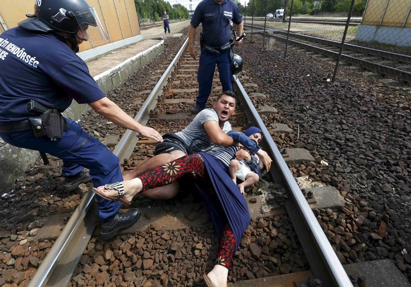 Photos Of The Year, Vladimir Putin workout, Mark Zuckerberg daughter, Barack Obama selfie, photo gallery of the year, picture of Jayalalithaa, Brazil President, Dilma Rousseff, German Chancellor, Angela Merkel, US President, Barack Obama, Charlie Hebdo shootings, Rohingya Bangladeshi migrants, Palestinian protester, nepal Earthquake, 100 lashes, Hungarian police, Syrian refugee, French President, Francois Hollande, रूसी राष्‍ट्रपति, व्‍लादिमिर पुतिन, बराक ओबामा, जयललिता, सीरियाई शरणार्थी, एंजेला मर्केल, 2015 की तस्‍वीरें, बेहतरीन तस्‍वीरें