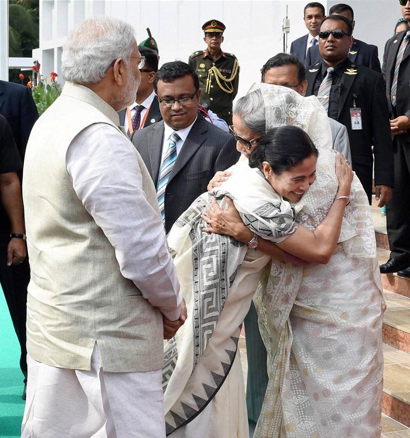 बांग्लादेश की राजधानी ढाका में भारत-बांग्लादेश के बीच बस सेवा की शुरुआत करने के दौरान बांग्लादेश की प्रधानमंत्री शेख हसीना और पश्चिम बंगाल की मुख्यमंत्री ममता बनर्जी एक-दूसरे गले मिलते और प्रधानमंत्री नरेंद्र मोदी उनकी ओर देखते हुए।