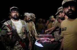 एलओसी पर हुई कथित झड़प में मारे गए पाकिस्तानी सैनिक के शव के साथ पाकिस्तानी सेना के जवान। (REUTERS/Fayyaz Hussain)