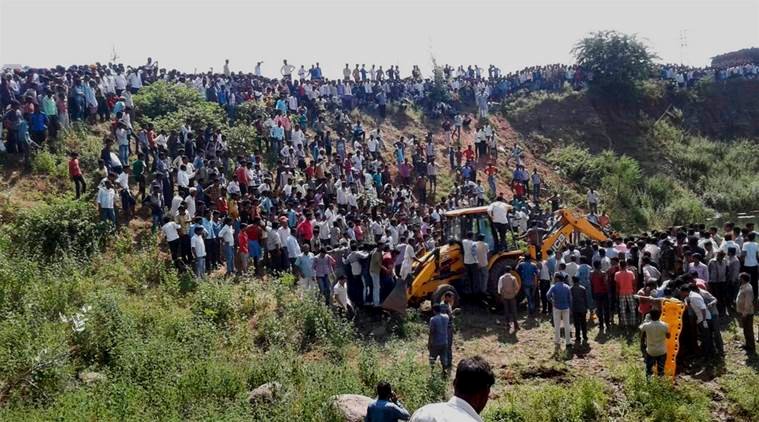 Ratlam: Rescue and relief operation in progress after a bus accidently fell down in a pond near Ratlam on Friday. PTI Photo (PTI10_14_2016_000057A)