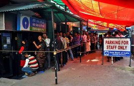 reuters-people-waiting-for-their-turn-to-take-money-at-atm