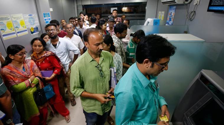 People wait to withdraw and deposit their money at an ATM kiosk in Kolkata, India, November 8, 2016. REUTERS/Rupak De Chowdhuri