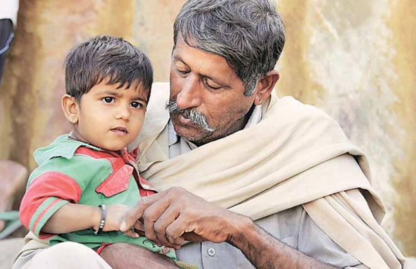 राइफलमैन प्रभु सिंह के पिता चंद्र सिंह और प्रभु सिंह की 10 महीने की बेटी पलक। (Express Photo)