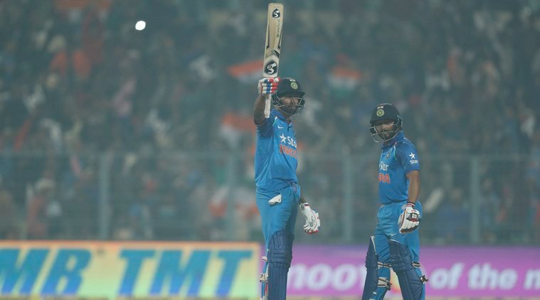 India's Hardik Pandya, left, raises his bat after scoring fifty runs as Kedar Jadhav stands during their third one day international cricket match against England at Eden Gardens in Kolkata, India, Sunday, Jan. 22, 2017. (AP Photo/Tsering Topgyal)