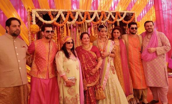 फैमिली के साथ तस्वीर खिंचवाते नील और रुक्मिणी। बता दें कि यह शादी उदयपुर में हो रही है।