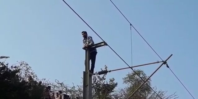 रेलवे ट्रेक की ओएचई लाइन पर चढ़ा हुआ धर्मेंद्र धाकड़।