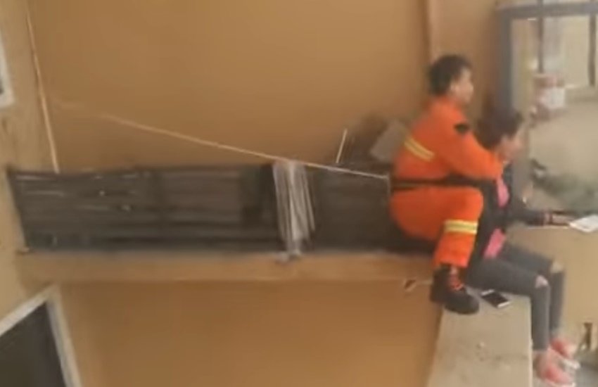 दमकल कर्मी को महिला तक पहुंचने में एक मिनट लगता है और वह तुरंत ही महिला को पकड़ लेता है। (Photo Source: Video Grab)