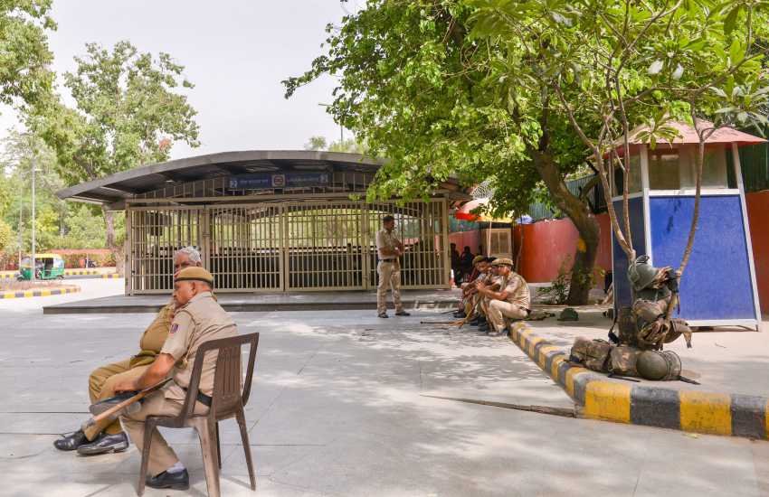 Aap Dharna: आम आदमी पार्टी के जुलूस के मद्देनजर बंद किए गए लोक कल्‍याण मार्ग मेट्रो स्‍टेशन के बाहर मौजूद पुलिसकर्मी। (Photo: PTI)