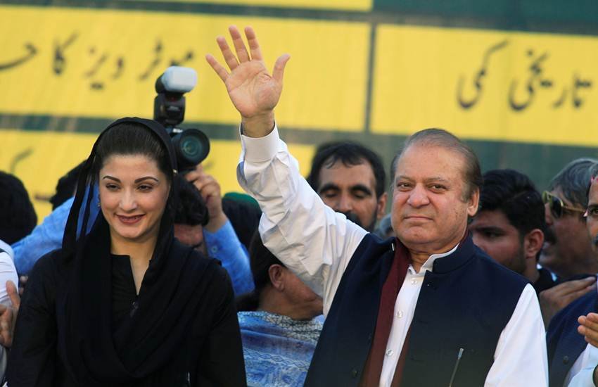 FILE PHOTO: Nawaz Sharif, former Prime Minister and leader of Pakistan Muslim League, gestures to supporters as his daughter Maryam Nawaz looks on during party's workers convention in Islamabad
