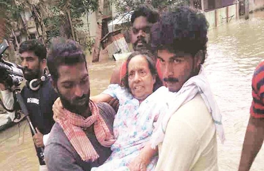 केरल बाढ़ प्रभावित लोगों की सहायता करते जिग्नेश (लाल गमछे में) की फाइल फोटो