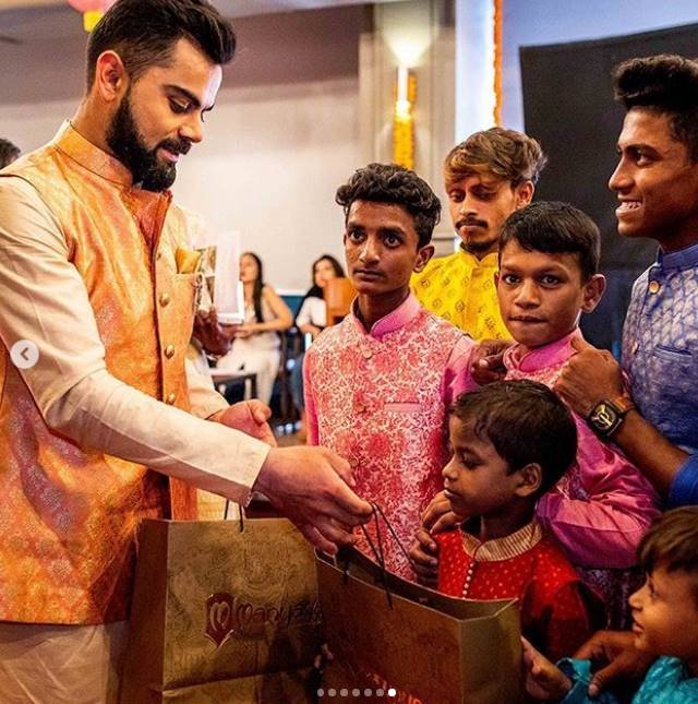 Virat Kohli Style, Stylish Indian Cricketers, Virat Kohli MensXP, Virat Kohli Fashion, Virat Kohli Dharavi kids, Virat Kohli Diwali, Virat Kohli Manyavar, kohli diwali with kids, kohli latest pics