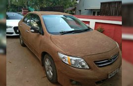 Toyota Corolla with cow dung, toyota cirolla price in india, Toyota Corolla covered with cow dung, Toyota Corolla features, ahmedabad, facebook