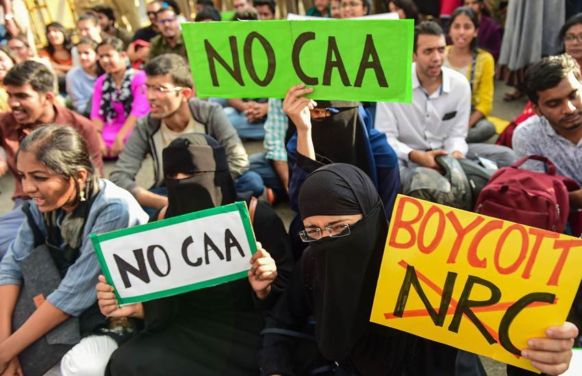 बैनर और तख्तियां लेकर CAA का विरोध करते नागरिक। (फोटोः पीटीआई)