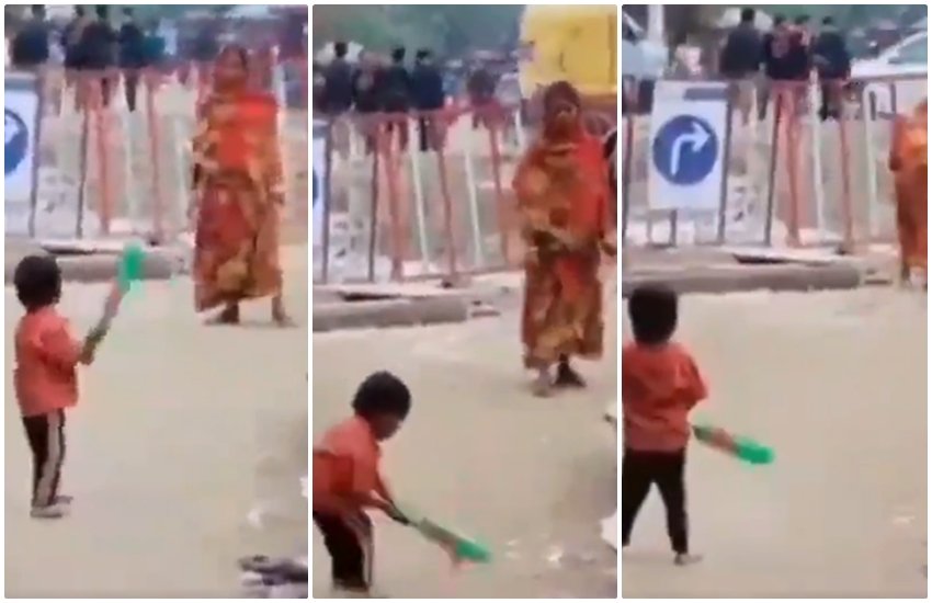 शहर की व्यस्त सड़क के किनारे अपने बच्चे को क्रिकेट खिलाती एक मां। (स्क्रीनशॉट)