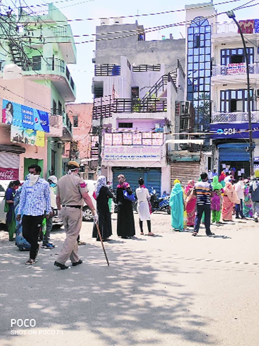 राशन के लिए लाइन लगाए लोग। राशन के लिए लाइन लगाए लोग।