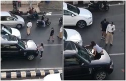 VIDEO: बीच सड़क में बोनट पर चढ़ कर महिला ने किया हंगामा, जाम खुलवाने के लिए पुलिस को करनी पड़ी मशक्कत