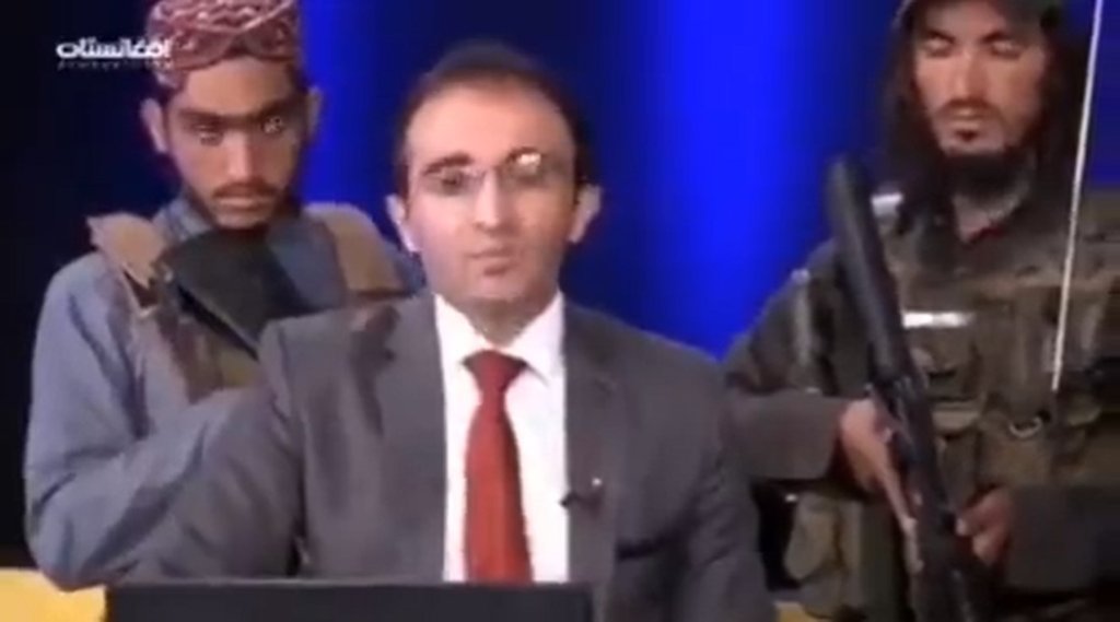 News Anchor surrounded by Talibani gunmen