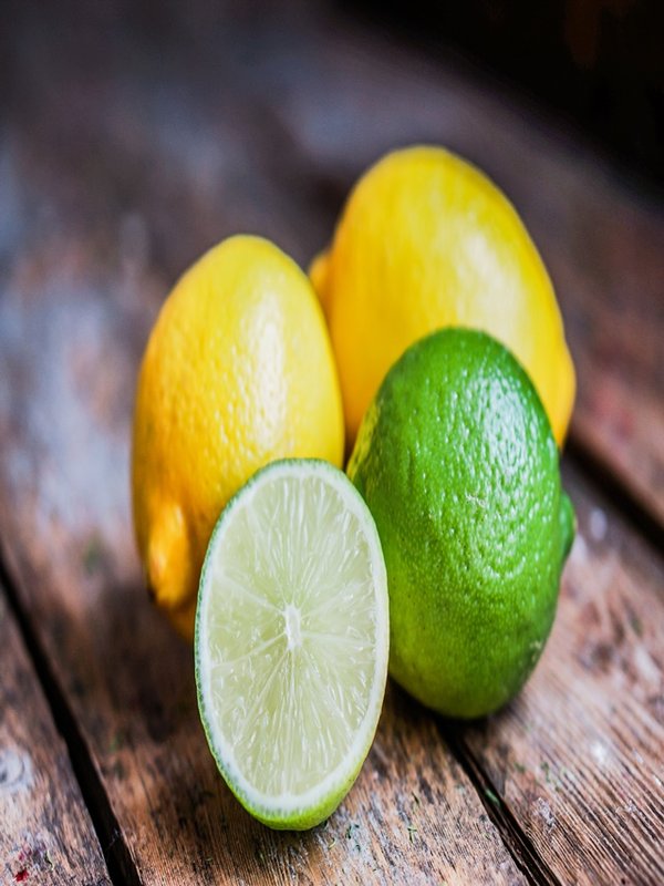 Lemon and limes on rustic wood