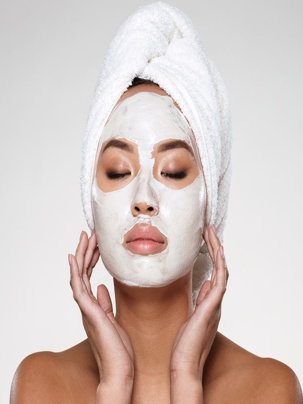 Portrait of beautiful lady with closed eyes put scrab on her face isolated