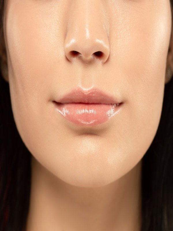 Beautiful young woman's full lips close-up, perfect skincare concept