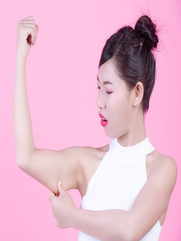 The girl raised the upper arm.