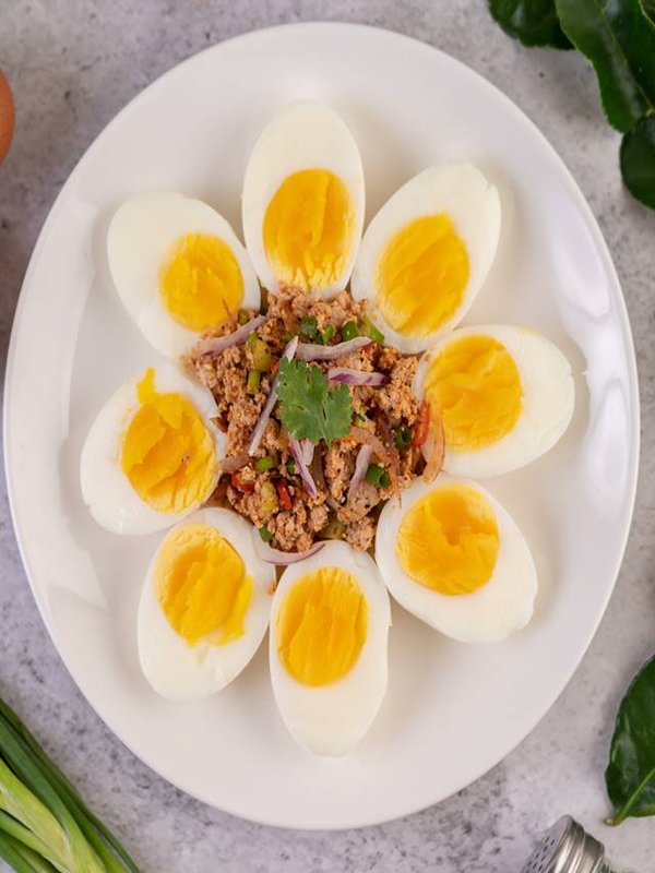 Half boiled egg and Pork Larb on a plate