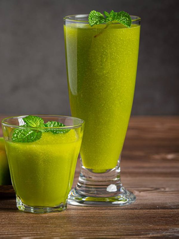 two glasses of melon juice put on wooden floor