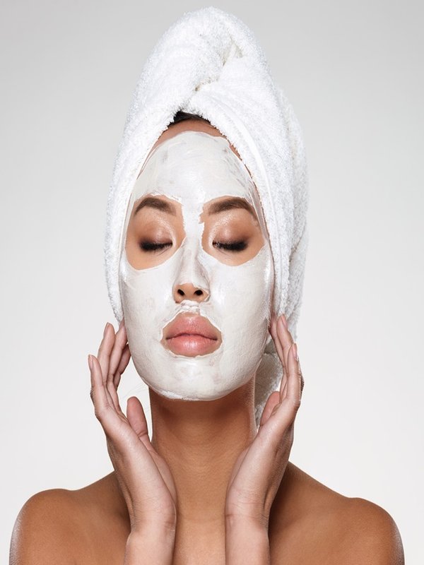 Portrait of beautiful lady with closed eyes put scrab on her face isolated