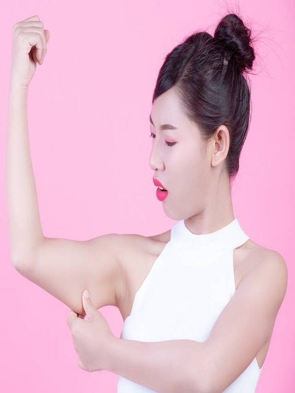 The girl raised the upper arm.