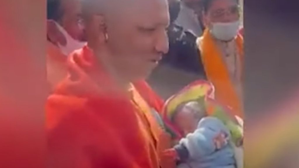 योगी आदित्यनाथ ने आगरा में भीड़ में खड़ी एक मुस्लिम महिला के गोद से बच्चे को लेकर दुलारा। (फोटो: स्क्रीनग्रैब)