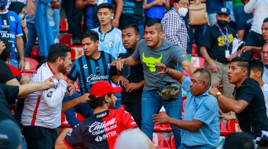 Fans clash during a Mexican soccer league match between the host Queretaro and Atlas from Guadalajara at the Corregidora stadium in Queretaro Mexico Saturday March 5 2022.jpeg