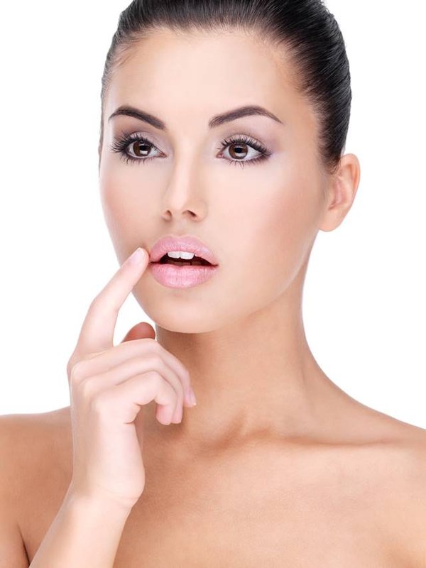 Face of a Pretty young woman with finger at lips