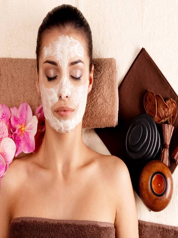 woman relaxing with cosmetic mask on face