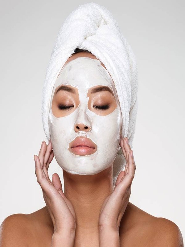 Portrait of beautiful lady with closed eyes put scrab on her face isolated