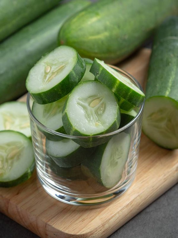 fresh cucumbers sliced on dark background