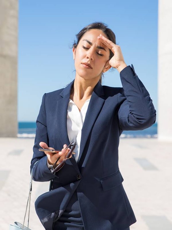 Frustrated business lady suffering from heat