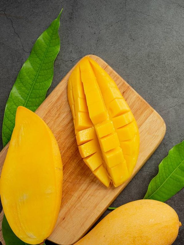 beautiful chopped ripe mango on dark wooden backgroud