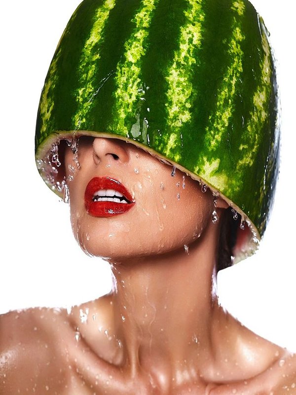 High fashion look.glamor closeup portrait of beautiful sexy young woman model with water-melon on head with water drops with red lips, with perfect wet clean skin