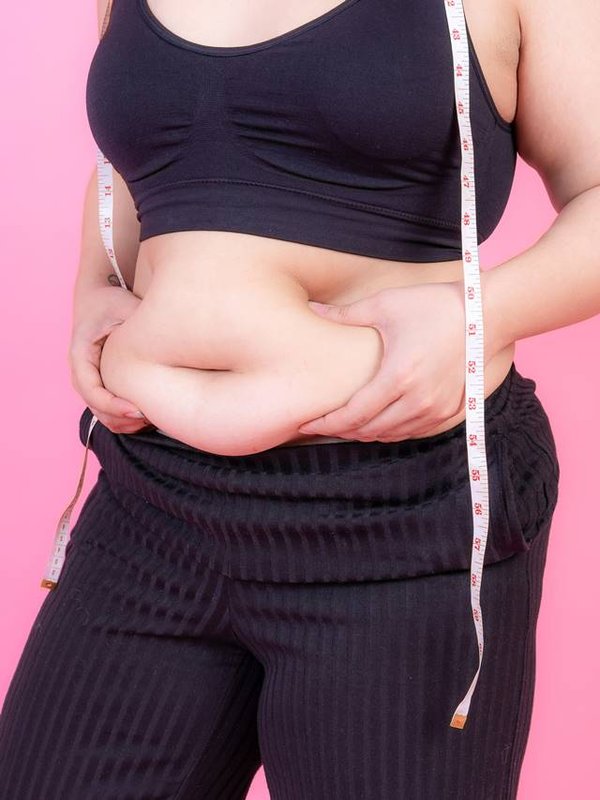 overweight-squeeze-belly-fat-with-measure-tape-her-neck