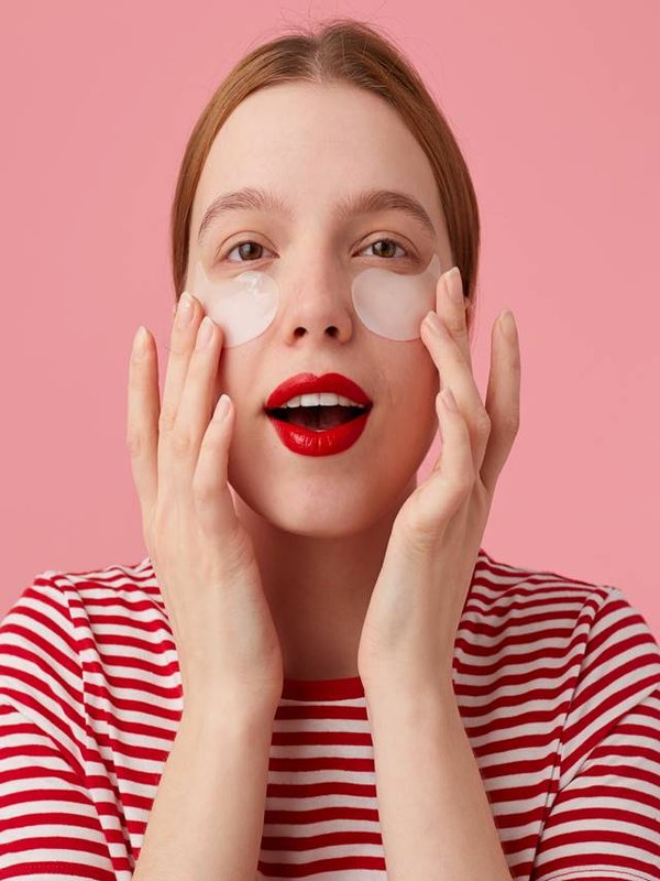 Cute young red-haired woman in a red striped T-shirt, with red l