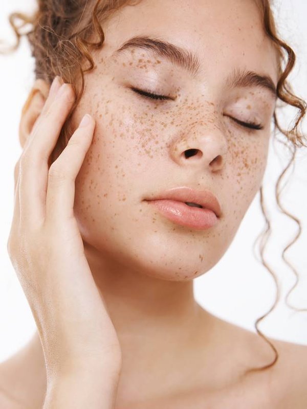Selfcare, cosmetology beauty concept. Sensual attractive relaxed naked redhead young woman freckled cheeks closed eyes gently touching cheek enjoying clean pure skin condition applying daily creme