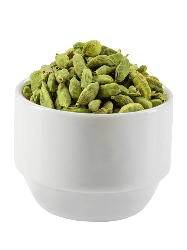 Green cardamom pods in a bowl isolated on white background with copy space for text or images. Spices, food, cooking concept. Close-up shot.