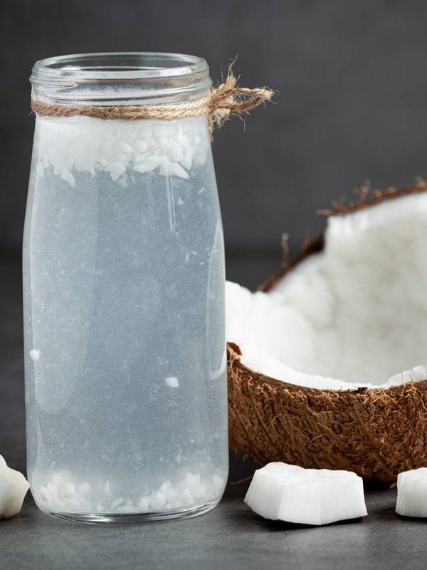 a bottle of coconut water put on dark background
