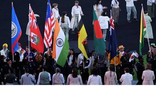 Flagbearers of participating countries hold the national flags of their respective countries during the closing ceremony of the Commonwealth Games 2022