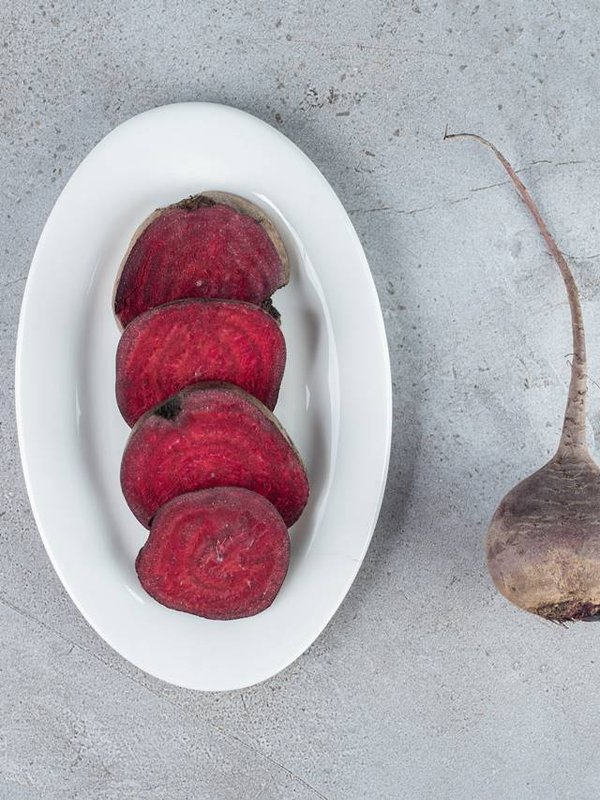 Sliced fresh beetroot vegetable on a dark board