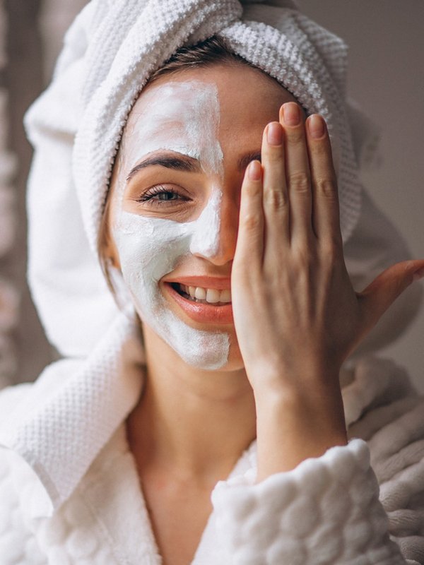 Portrait of a woman with a facial mask half face