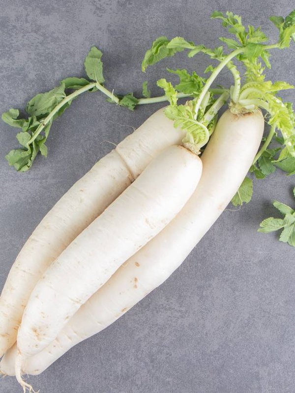 A stack of white radishes on the marble background
