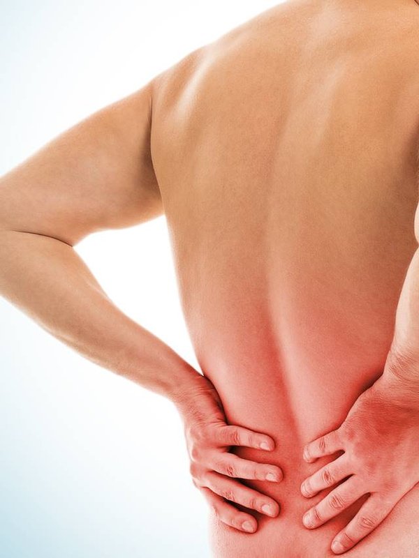 Man holds his back due to pain