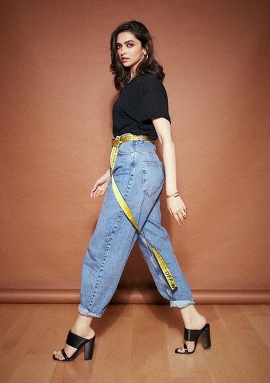 Deepika Padukone in black top and blue denim
